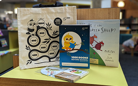 1000 Books Before School goodie bag, including a reading log, canvas bag, activity pack and picture book.