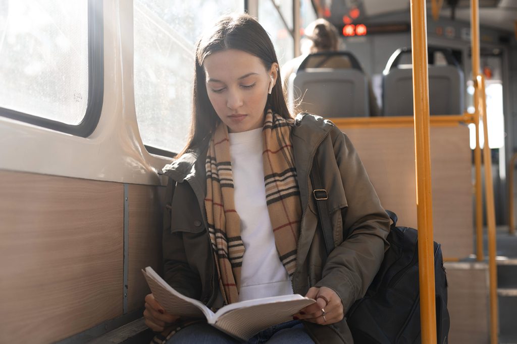 woman sitting on a train reading