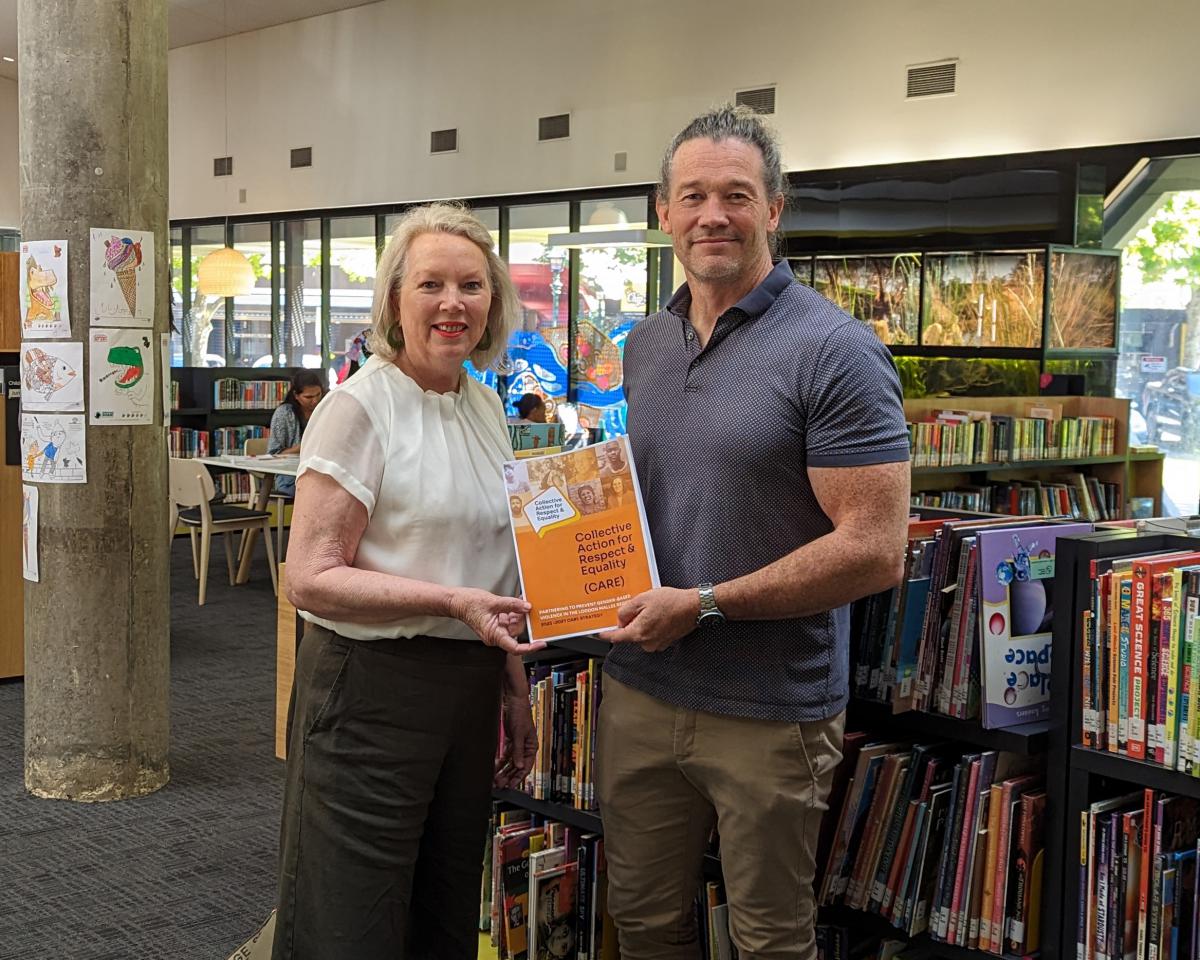 Women's Health Loddon Mallee CEO Tricia Currie and Goldfields Libraries CEO Mark Hands with the CARE Paerntership statement at Bendigo Library