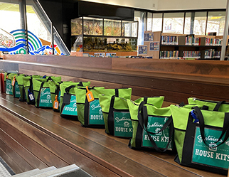 Sustainable House Kits lined up on a bench inside Bendigo Library.